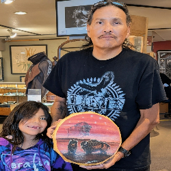 Picture of Sandpainting art demonstrations by Navajo artist Bilson Kee. Live music, food and friendships